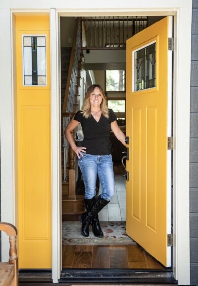 Cindi Sorrentino standing in a doorway with yellow doors